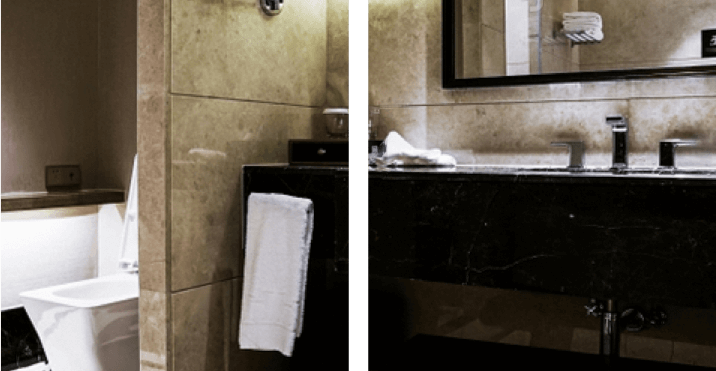 A modern bathroom with dark cabinetry